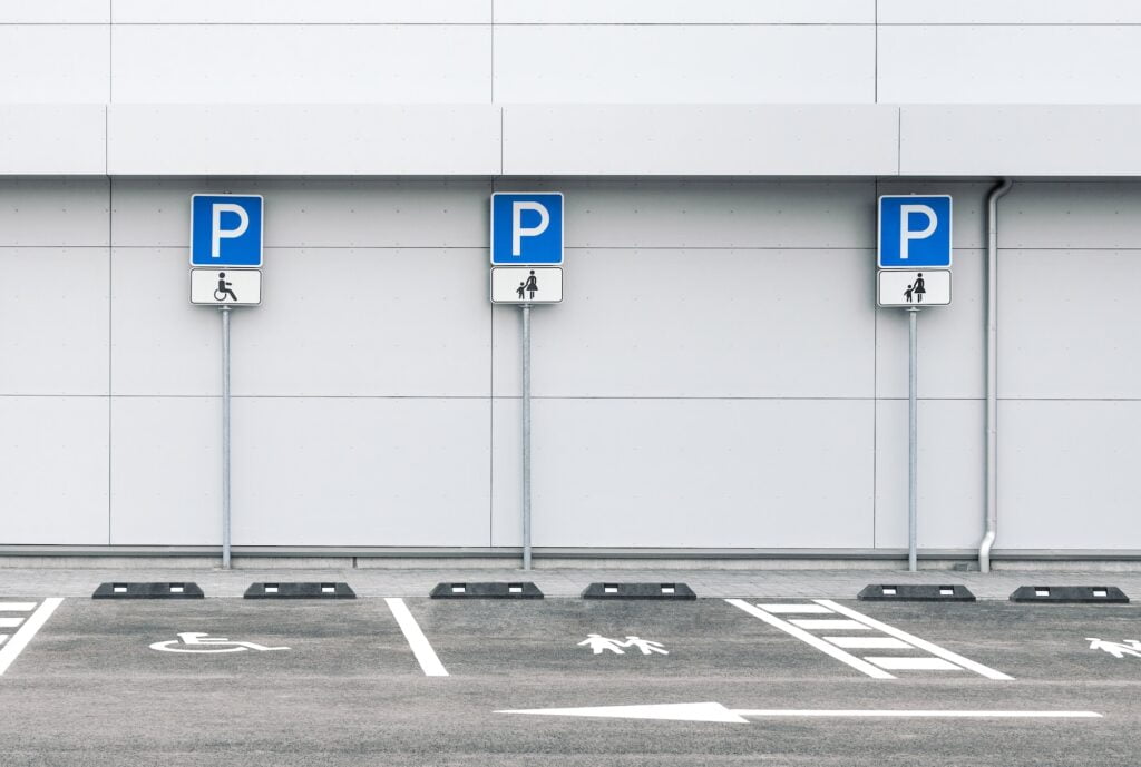 Empty car parking lot at a supermarket with family and disability parking places