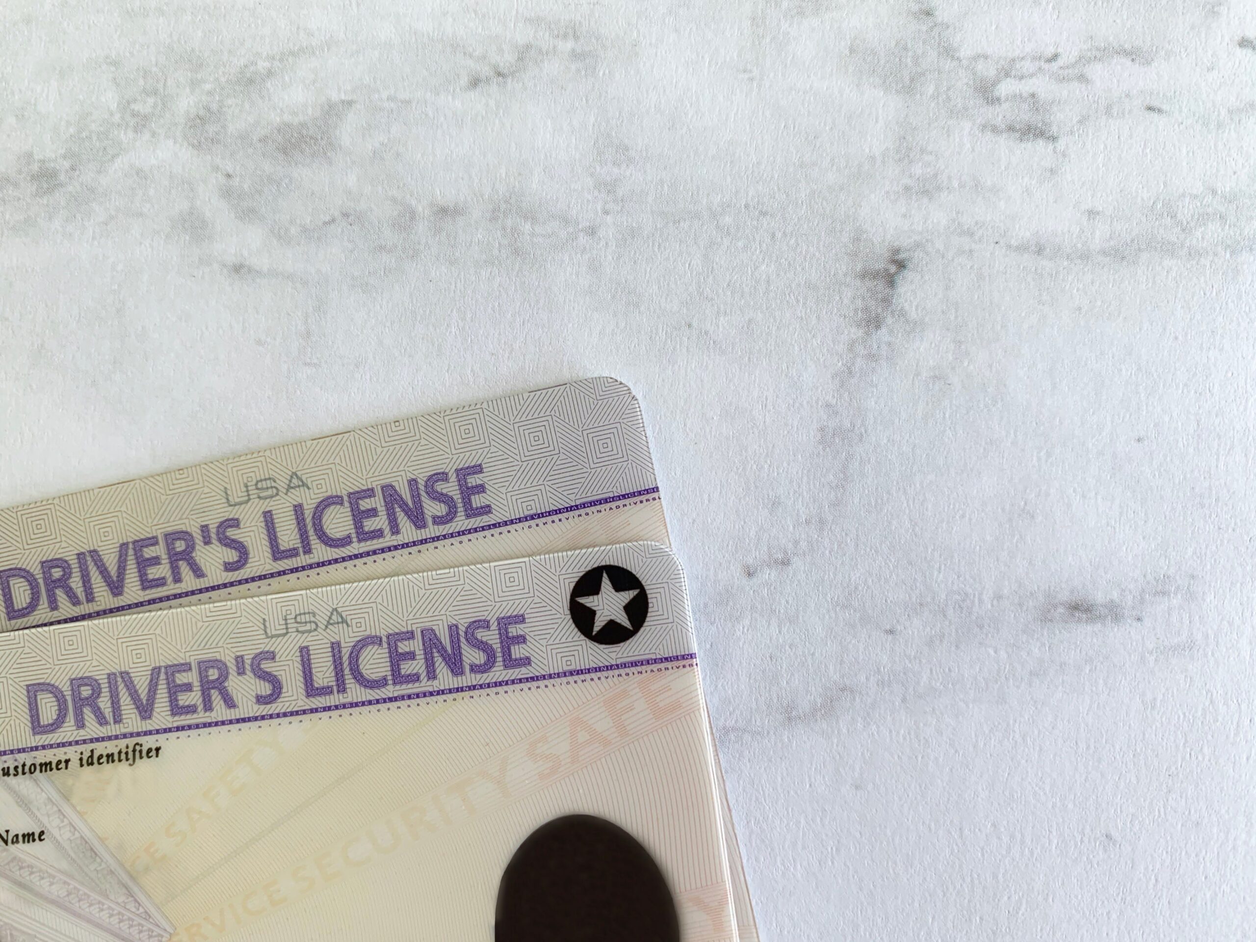 Old driver’s license & the new REAL ID with the star which will be required to travel after October