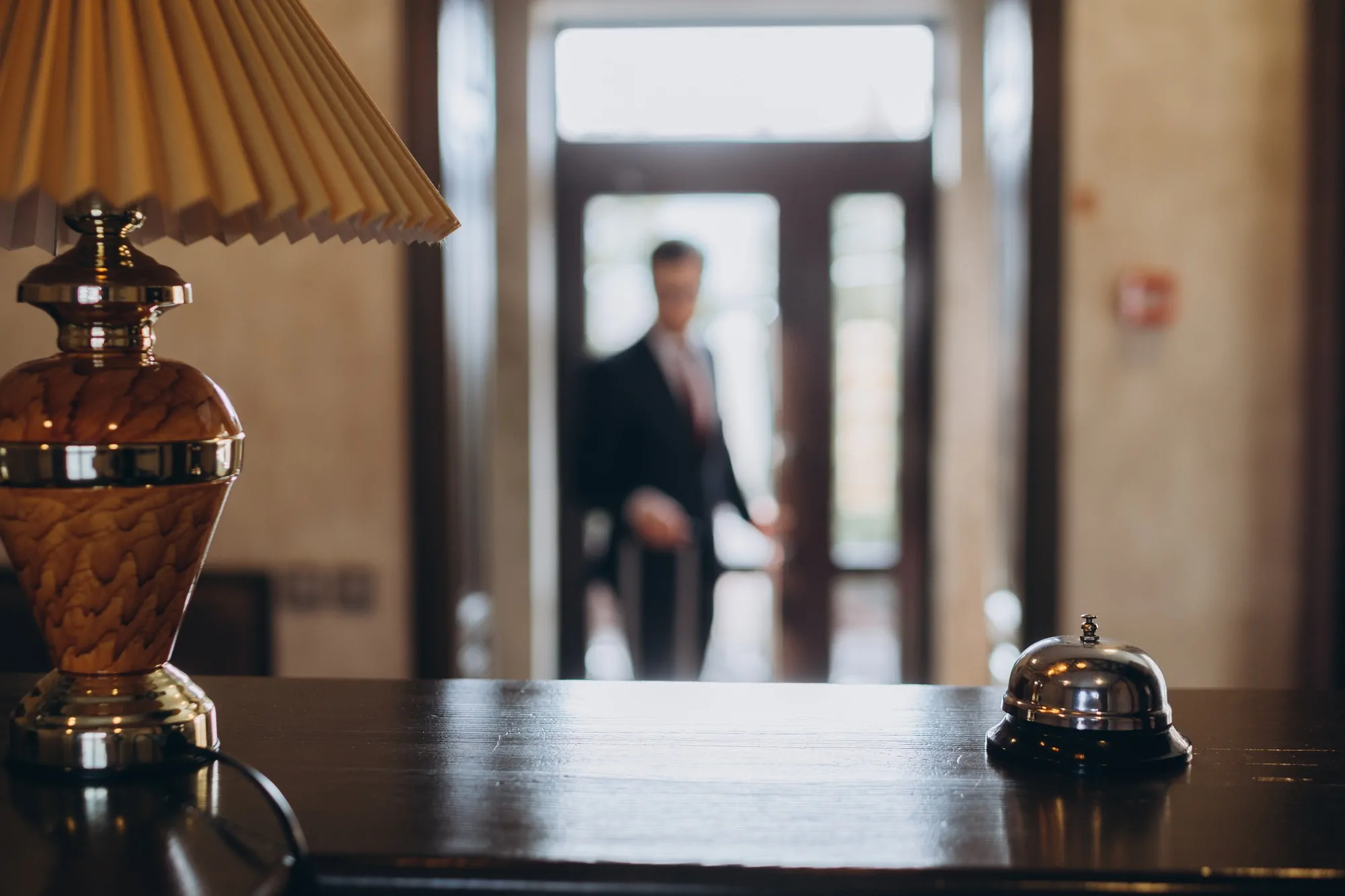 Arrival at the hotel. Reception desk with a bell in the hotel lobby.
